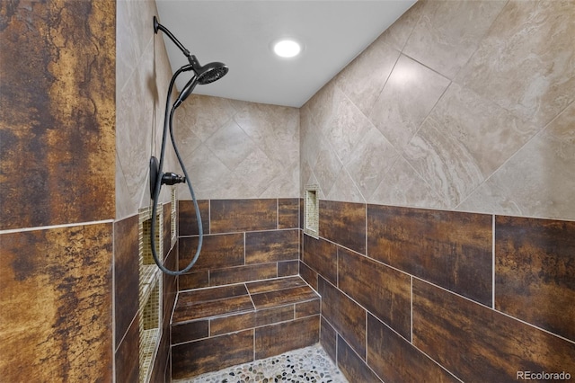 details with recessed lighting and a tile shower