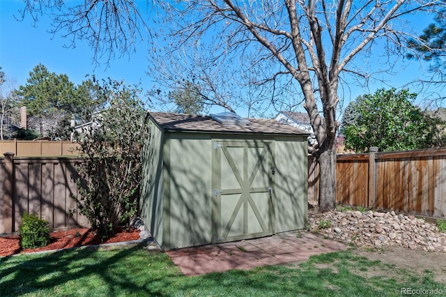 view of shed featuring a fenced backyard