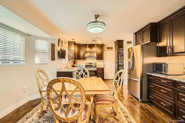 dining room featuring dark hardwood / wood-style flooring and sink