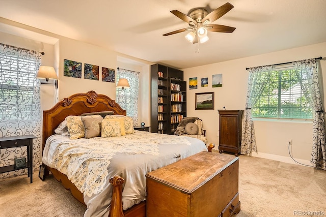 bedroom featuring light colored carpet and ceiling fan