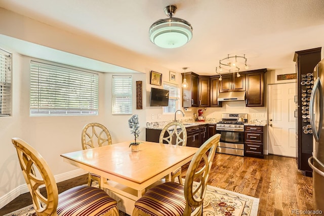 dining room featuring dark hardwood / wood-style flooring and sink