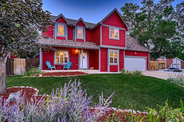 view of front of property featuring a front lawn, a porch, and a garage