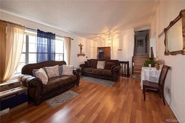 living room featuring wood finished floors and stairway