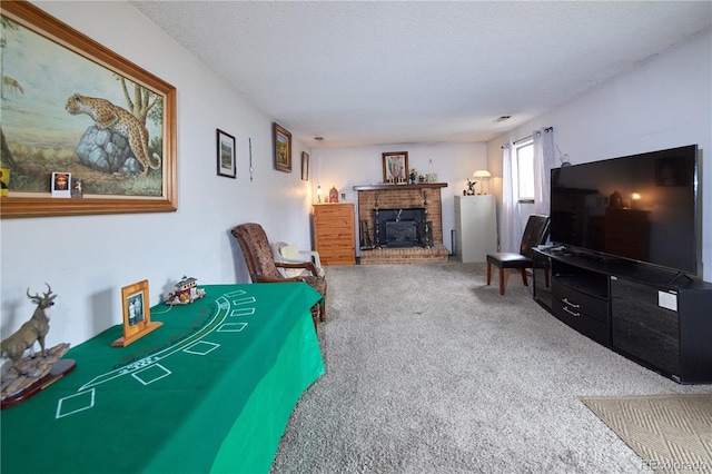 living area with a textured ceiling, carpet, and a fireplace