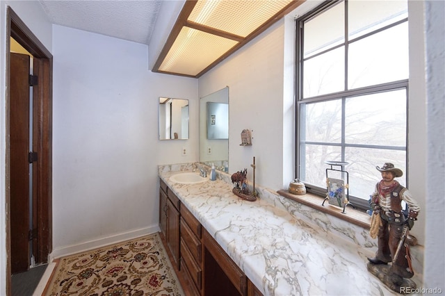 bathroom with baseboards and vanity