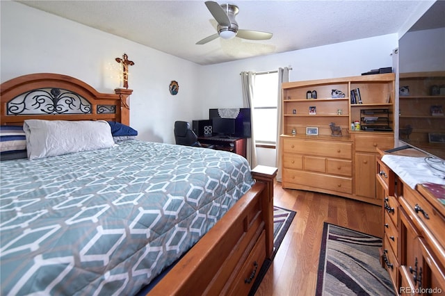 bedroom featuring a textured ceiling, ceiling fan, and wood finished floors