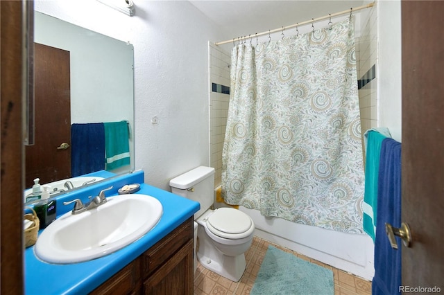 bathroom featuring shower / bath combo with shower curtain, a textured wall, toilet, and vanity