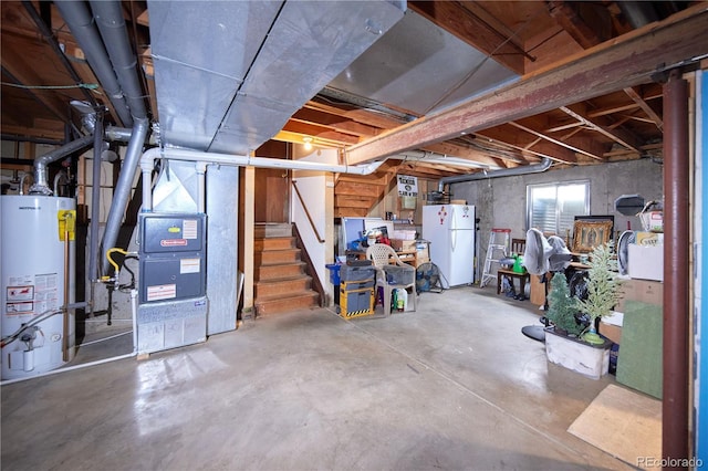basement featuring freestanding refrigerator, stairs, heating unit, and gas water heater