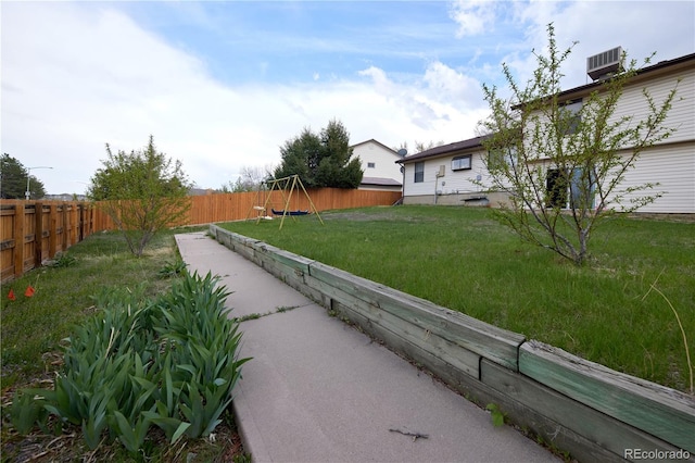 view of yard with a fenced backyard and a playground