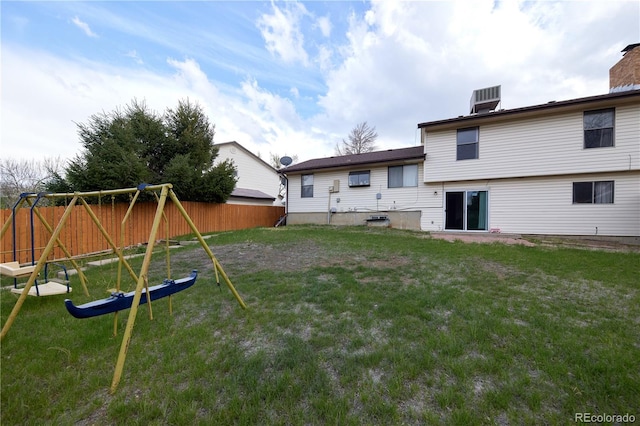 view of yard featuring central AC unit, a playground, and fence