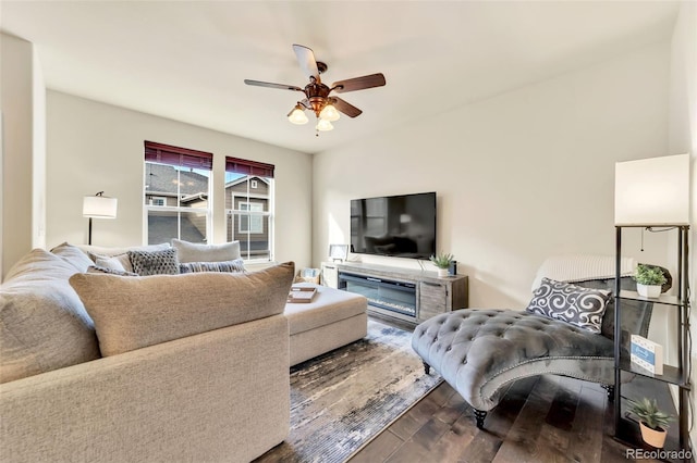 living room featuring ceiling fan and dark hardwood / wood-style floors