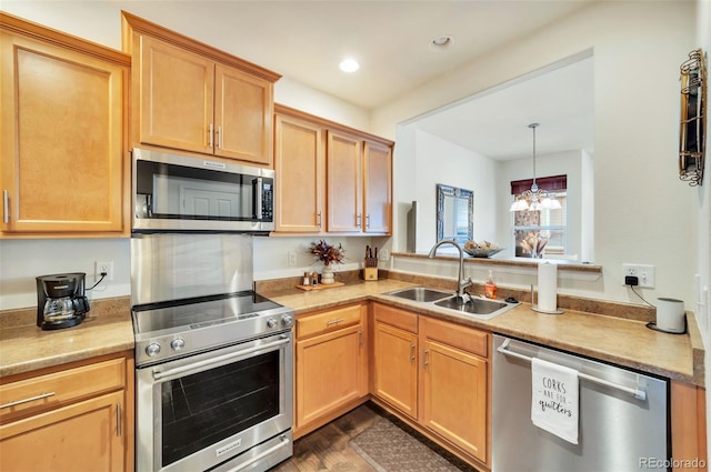 kitchen with pendant lighting, sink, dark wood-type flooring, appliances with stainless steel finishes, and a chandelier