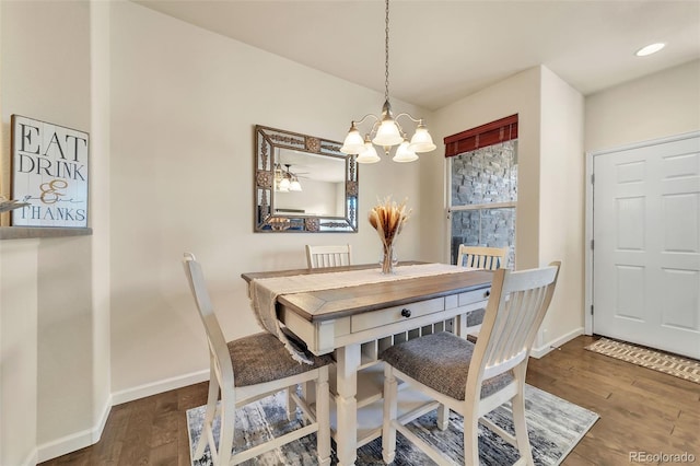 dining room featuring dark hardwood / wood-style floors and a chandelier