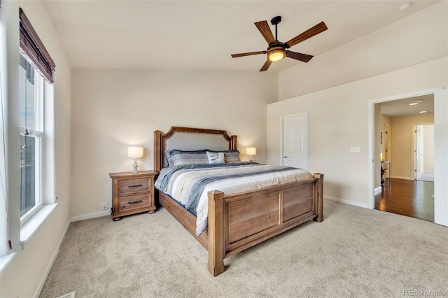 bedroom with light carpet and ceiling fan