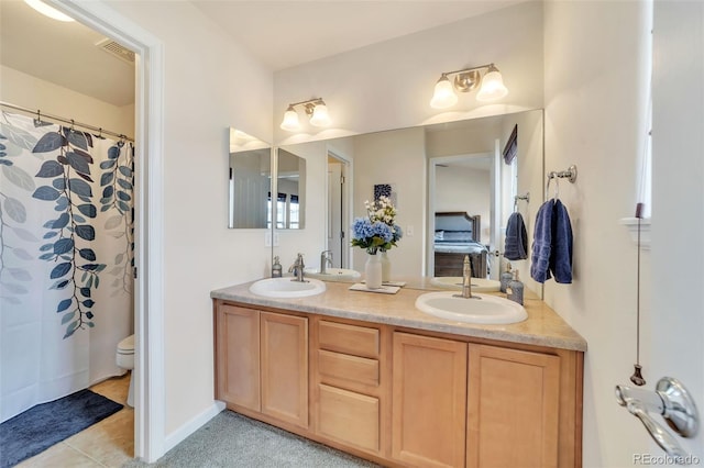 bathroom with vanity, tile patterned floors, and toilet