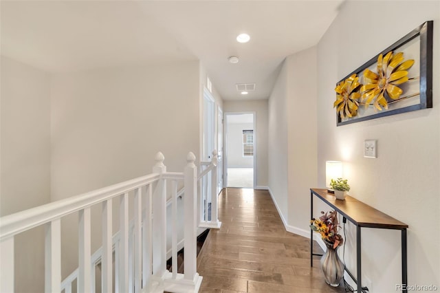 hallway with hardwood / wood-style floors