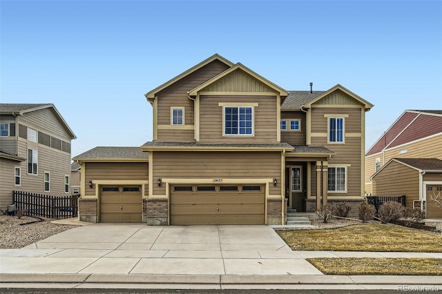 craftsman house with driveway, an attached garage, fence, and board and batten siding