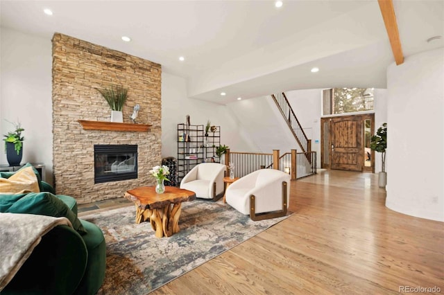 living area featuring a fireplace, recessed lighting, and wood finished floors