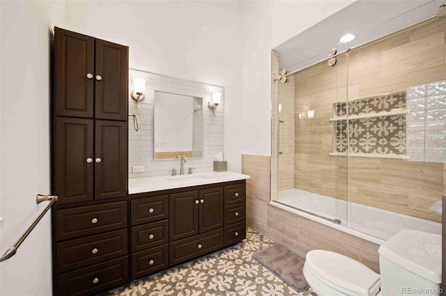 full bathroom with vanity, tile patterned floors, tiled shower / bath, and toilet