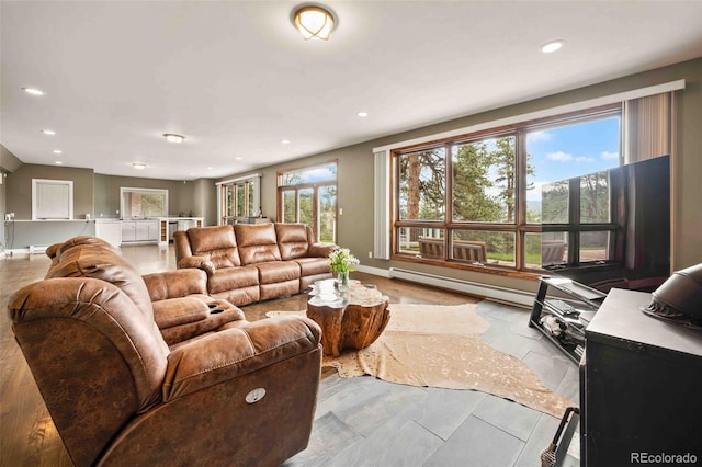 living room with baseboards, recessed lighting, and a wealth of natural light