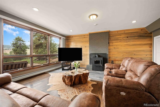 living area featuring wooden walls, baseboard heating, recessed lighting, and wood finished floors
