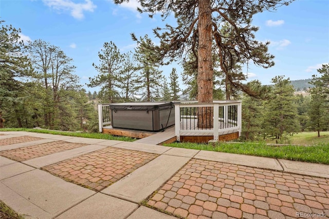 view of patio / terrace featuring a hot tub and a wooden deck