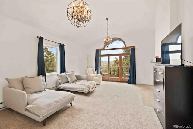 living room with an inviting chandelier, a baseboard heating unit, and light colored carpet