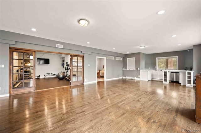 workout room featuring recessed lighting, baseboards, visible vents, and wood finished floors