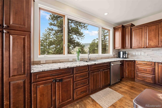 24140 US Highway 40, Golden, CO 80401 - kitchen with stainless steel dishwasher, backsplash, light stone countertops, and dark wood-type flooring