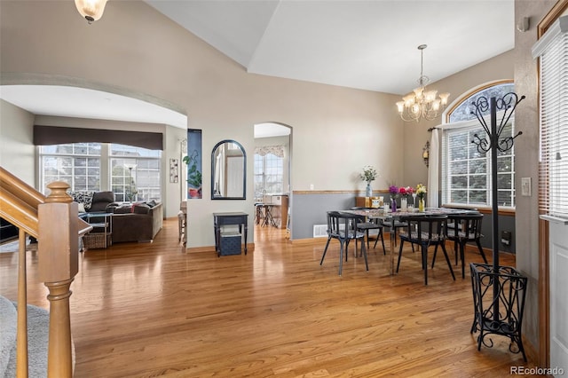 dining room featuring a healthy amount of sunlight, a chandelier, and light hardwood / wood-style flooring