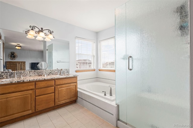 bathroom featuring independent shower and bath, vanity, and tile patterned floors