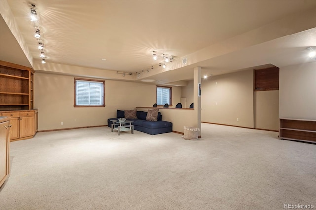 living room featuring rail lighting and light colored carpet