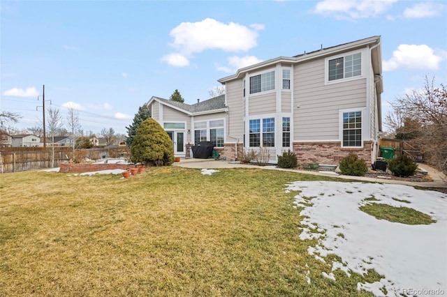 rear view of house featuring a lawn and a patio area