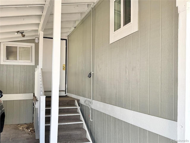 8480 Adams Way, Denver, CO 80229 - stairs with wooden walls and unfinished concrete flooring