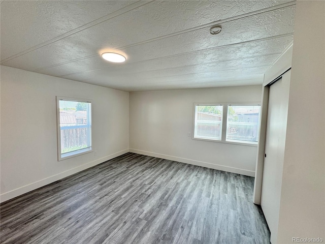 8480 Adams Way, Denver, CO 80229 - unfurnished room featuring a textured ceiling, plenty of natural light, and wood finished floors