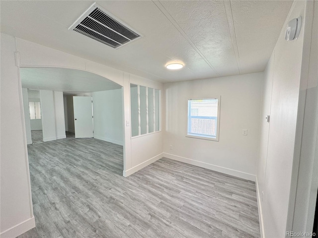 8480 Adams Way, Denver, CO 80229 - spare room with wood finished floors, a textured ceiling, and arched walkways