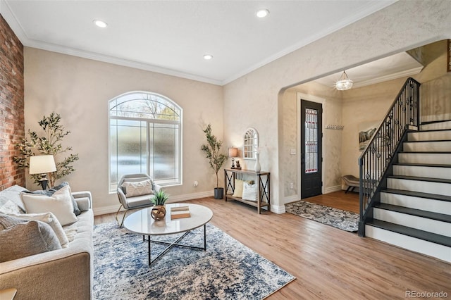 living room with baseboards, ornamental molding, wood finished floors, stairs, and recessed lighting