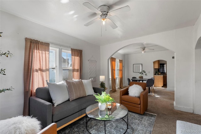 living room featuring ceiling fan and carpet