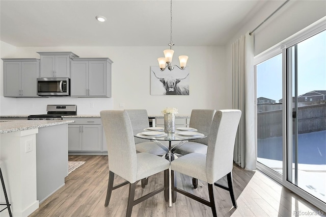 dining room featuring light hardwood / wood-style floors and an inviting chandelier