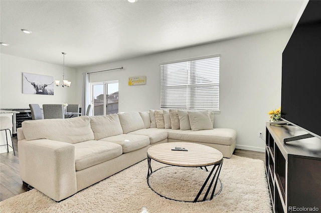 living room featuring hardwood / wood-style floors and a notable chandelier