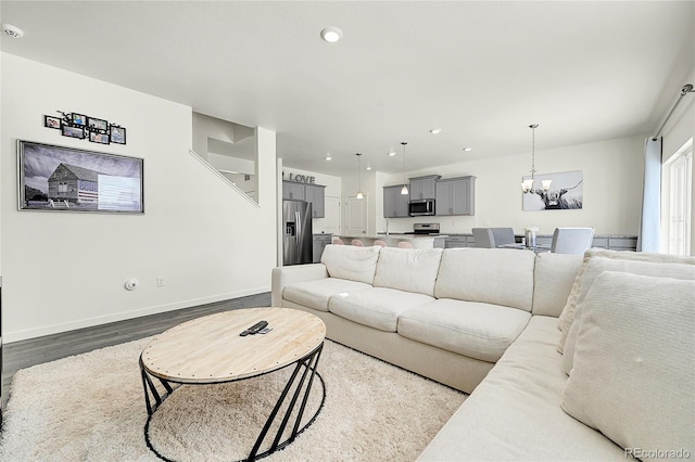 living room featuring hardwood / wood-style floors and a notable chandelier