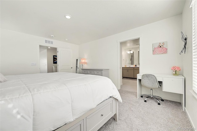 carpeted bedroom with ensuite bathroom