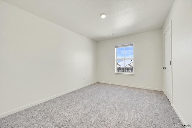 unfurnished room featuring carpet