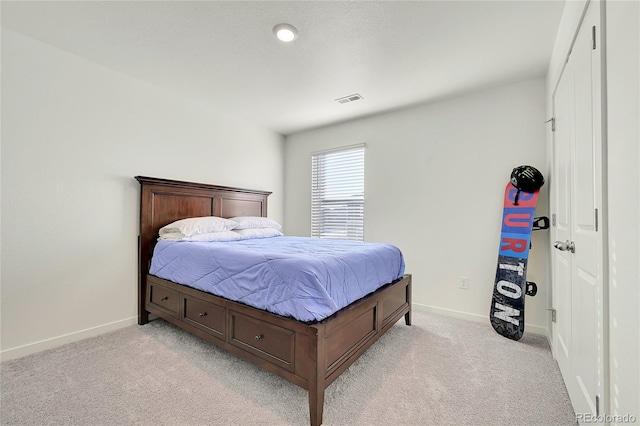 bedroom featuring baseboards, light carpet, and visible vents