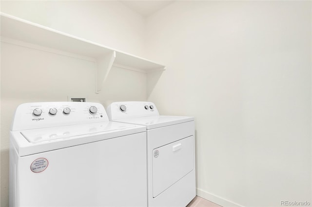 washroom with baseboards, laundry area, and independent washer and dryer