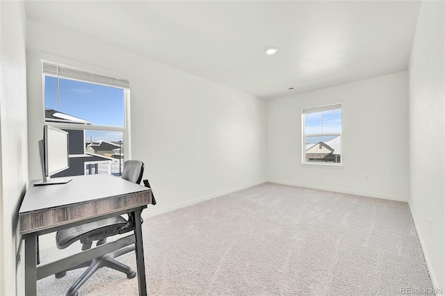 office area featuring light colored carpet and baseboards