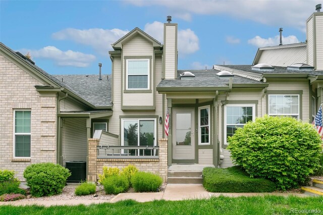 4880 Walking Horse Pt, Colorado Springs, CO 80923 - view of front of property with a chimney and a shingled roof