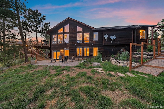 26452 Wolverine Trl, Evergreen, CO 80439 - rear view of property featuring a patio, stairs, and a deck