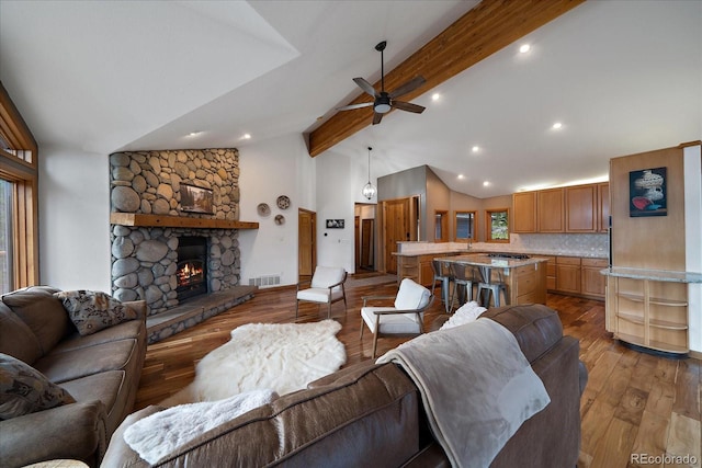 26452 Wolverine Trl, Evergreen, CO 80439 - living room with ceiling fan, beam ceiling, light wood finished floors, plenty of natural light, and high vaulted ceiling