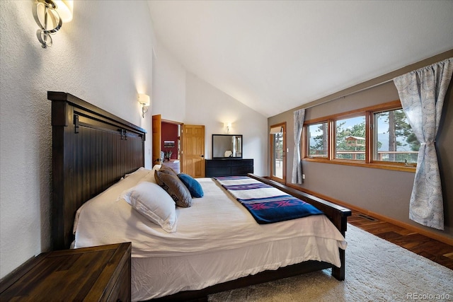 26452 Wolverine Trl, Evergreen, CO 80439 - bedroom featuring wood finished floors, baseboards, and high vaulted ceiling